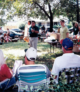 Ronnie Garner, Jr. holding an estate auction